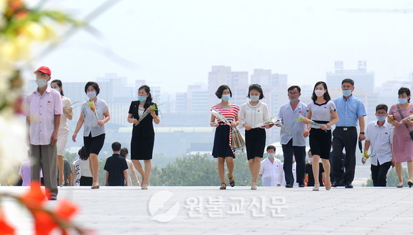 7월 8일 김일성 주석 추모일을 맞아 꽃을 들고 만수대언덕을 오르는 평양 시민들.